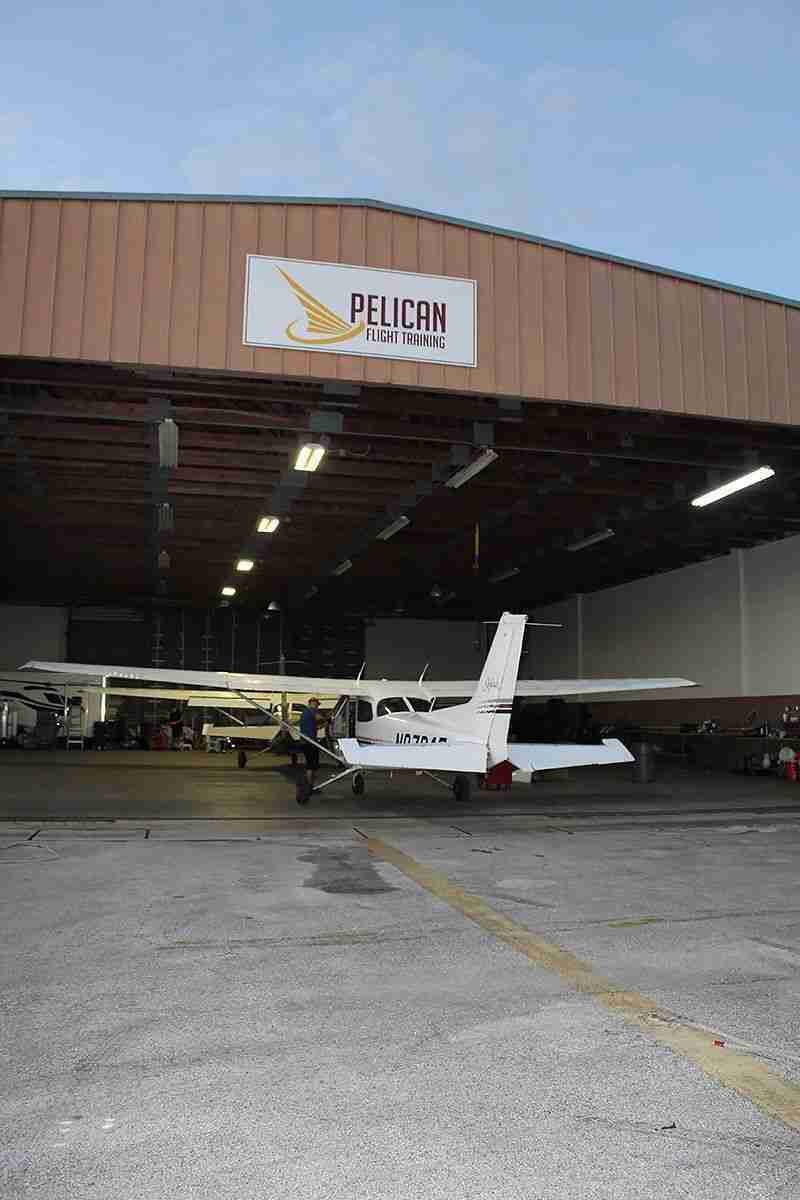 Pelican Flight School students standing in front of an airplane - Photo 3